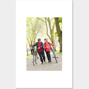 Active senior couple walking bicycles in park (F023/0128) Posters and Art